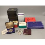 A group of Royal Mint UK proof and brilliant uncirculated coins.including a 1/10th oz. gold coin,