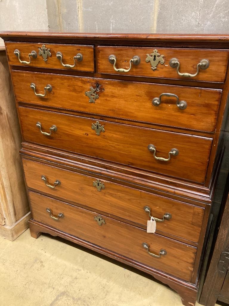 An early 19th century two part fruitwood chestfitted two short drawers and four graduated long