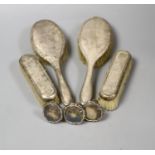 Four silver mounted brushes and three 830s mounted stoppers.