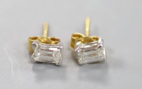 A pair of millennium cut diamond and gold stud earrings.