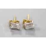 A pair of millennium cut diamond and gold stud earrings.