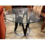 A contemporary circular glass top table, 120cm diameter, height 77cm