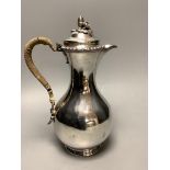 A Victorian silver baluster hot water jug, with acorn finial, by George Fox, London, 1876, height