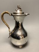 A Victorian silver baluster hot water jug, with acorn finial, by George Fox, London, 1876, height