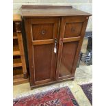 An Edwardian mahogany two door compactumAn Edwardian mahogany two door compactum