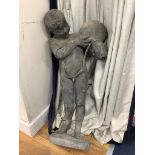 A lead figure of a boy carrying a water pitcher (a.f.),
