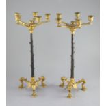 A pair of Barbedienne style five branch ormolu candelabra, 19th century,each raised on three puma