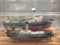 A scale model of the British Railways tug 'Meeching' (Newhaven) and another smaller model of a tug,
