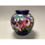 A Moorcroft blue ground bulbous Orchid pattern vase,blue signature to base,H 15cm