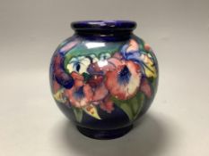 A Moorcroft blue ground bulbous Orchid pattern vase,blue signature to base,H 15cm