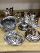 A collection of plated items, including a three-piece tea service, four entrée dishes and covers,