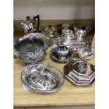 A collection of plated items, including a three-piece tea service, four entrée dishes and covers,