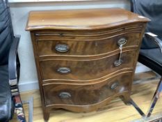 A George III design mahogany serpentine chest, brushing slide and three drawers, width 77cm depth