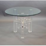 A 1970's German glass top tablewith a heavy circular bevelled clear plate glass top raised on a