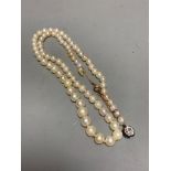 An early 20th century single strand graduated cultured? pearl necklace, with old cut diamond set