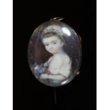 A Georgian miniature oval watercolour portrait of a child with flowers, in gold pendant brooch