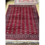 A Bokhara burgundy ground carpet, 284 x 244cm