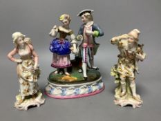 A Continental porcelain group of a couple picking flowers and a similar pair of figuresdepicting a