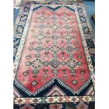 A Cauasian design red ground carpet, 310 x 194cm