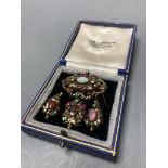 A Victorian yellow metal, enamel and multi gem set suite of jewellery (adapted), comprising a drop