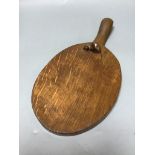 A 'Mouseman' carved wooden cheese board, length 37cm