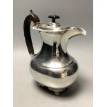 A London shape silver hot water pot with ebonised handle and finial,London 1909, Edward Barnard &