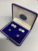 A cased four piece white metal (stamped 750) and sapphire set octagonal dress stud set, comprising
