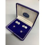 A cased four piece white metal (stamped 750) and sapphire set octagonal dress stud set, comprising