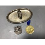 A Chinese white metal oval pen rest, 11.7cm and an Edwardian Coronation Celebration medallion.