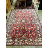 A Caucasian design red ground carpet, 310 x 224cm