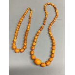 Two single strand graduated oval amber bead necklaces, 60cm & 42cm, gross weight 60 grams.