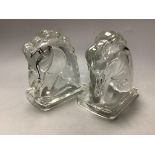 A pair of American press moulded glass horse head bookends, height 14cm