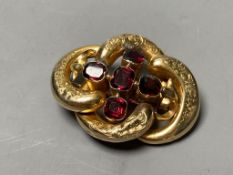 A Victorian engraved yellow metal and five stone garnet set openwork scroll brooch (a.f.),45mm,