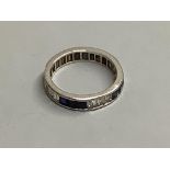 An 18ct white gold calibre-cut diamond and sapphire eternity ring(the diamonds and sapphires set