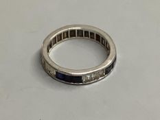 An 18ct white gold calibre-cut diamond and sapphire eternity ring(the diamonds and sapphires set