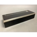 An Art Deco black enamel and chrome cigarette box