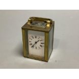 A brass cased miniature timepiece, height 6cm excluding handle.