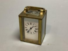 A brass cased miniature timepiece, height 6cm excluding handle.