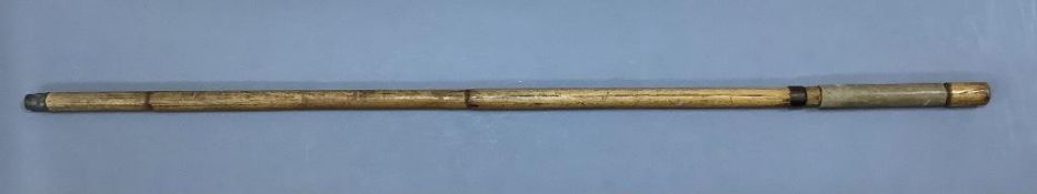 A 19th century bamboo swordstick, with vellum mounted handle and worn blued steel blade, overall