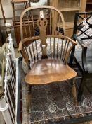 An early 20th century elm and beech Windsor comb back elbow chair, width 52cm, depth 50cm, height