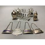 A pair of octagonal silver mustard pots and spoons, an egg-shaped salt, a baluster pepper, a small