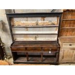 A George III oak dresser,the upper section fitted two shelves (with remains of old lining paper)