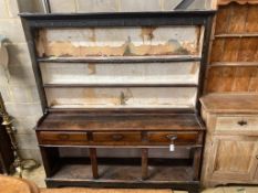 A George III oak dresser,the upper section fitted two shelves (with remains of old lining paper)