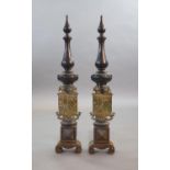 A substantial pair of 19th century heraldic cast iron fire dogs,with pointed baluster finals above