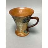 A Doulton Lambeth cycling related stoneware mug, c. 1900, height 12cm