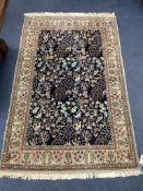 A Qum 'Tree of Life' part silk rug,the indigo field decorated with deer, rabbits, birds, flowers