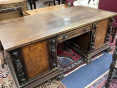 A large late 19th century oak and walnut kneehole desk, width 180cm depth 91cm height 78cm
