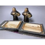 A pair of painted spelter monk spill vases,17cm, and a postcard album