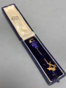 A 9ct gold and enamel 'The Andrew Football Cup, 1908' 68mm and one other 9ct gold stick pin, gross