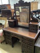 A late 19th century Flemish carveed oak kneehole dressing table, width 136cm depth 56cm height